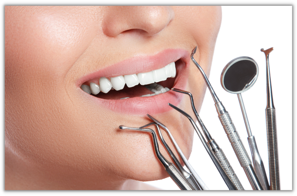 A woman with her teeth and mouth open holding several dental instruments.